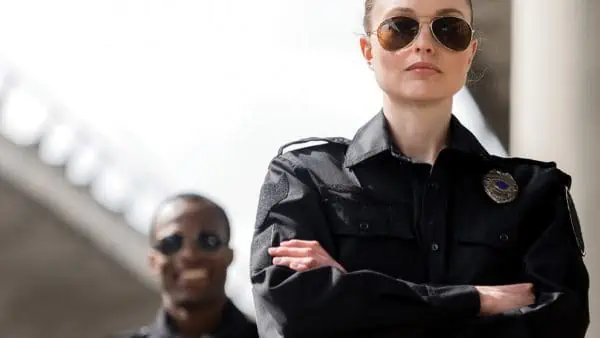 Female police officer with male police officer in background